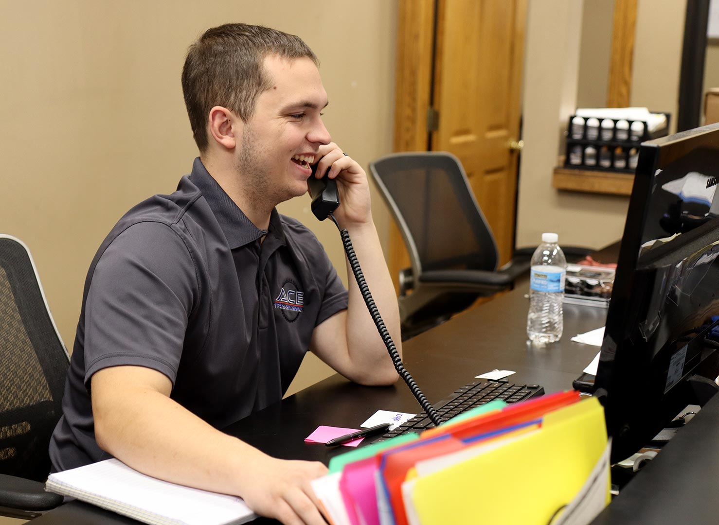 A customer service employee talking on the phone in a transmission shop in Springfield, Missouri.
