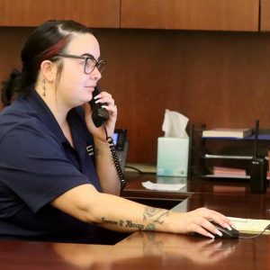 A customer service representative takes a call at a wholesale remanufactured transmission factory.